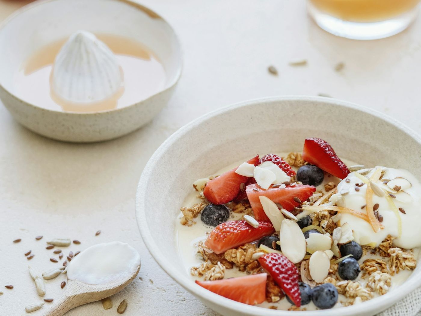 A bowl of yogurt with strawberries, blueberries and granola
