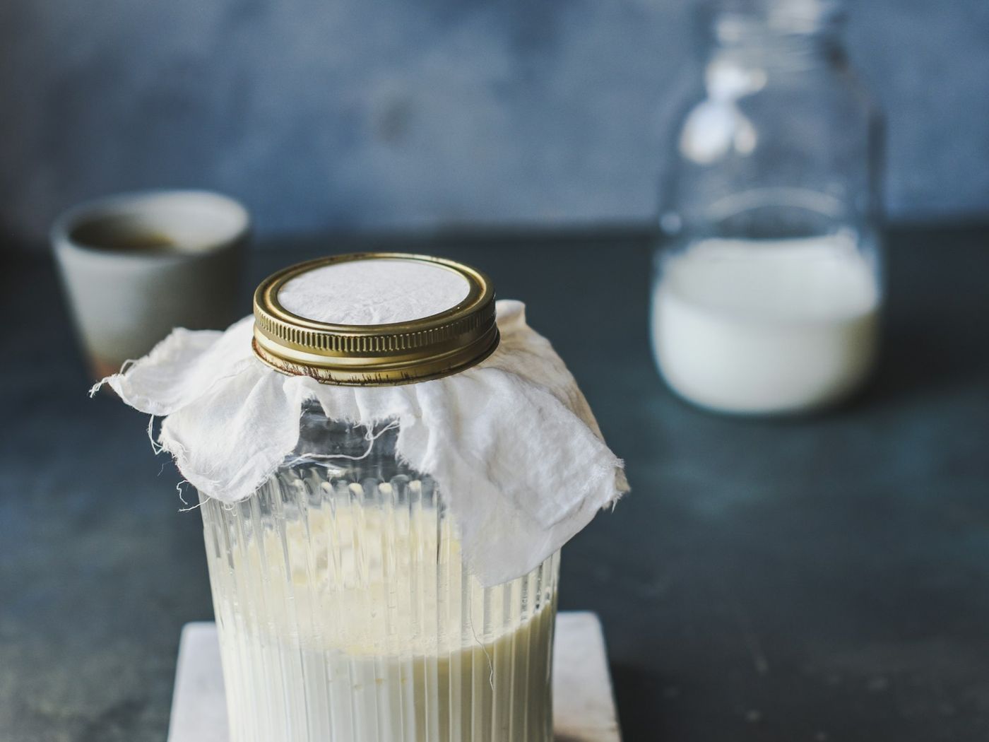 A glass jar covered with cloth while fermenting